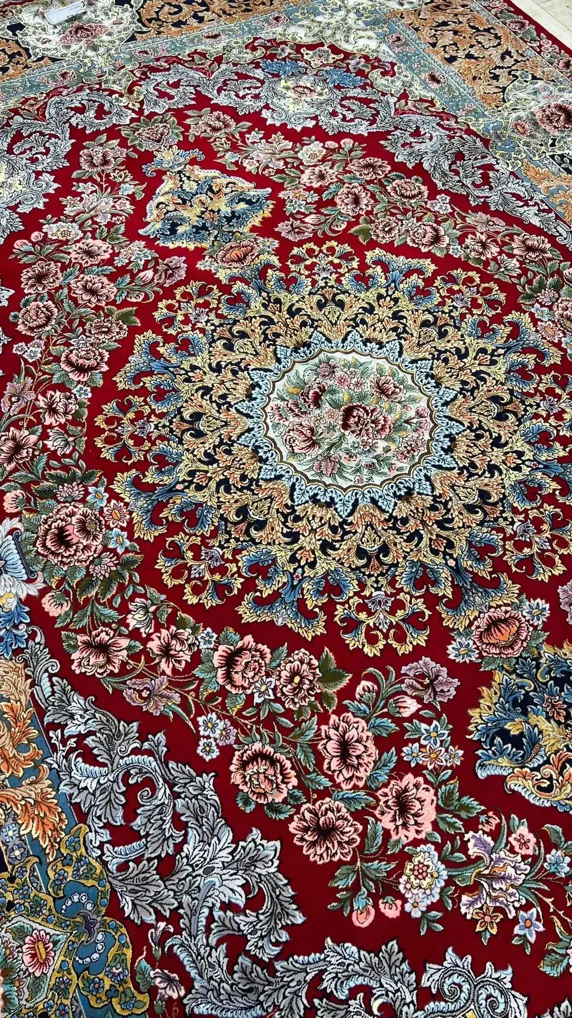 Handcrafted Persian rug with red base and floral patterns for sale