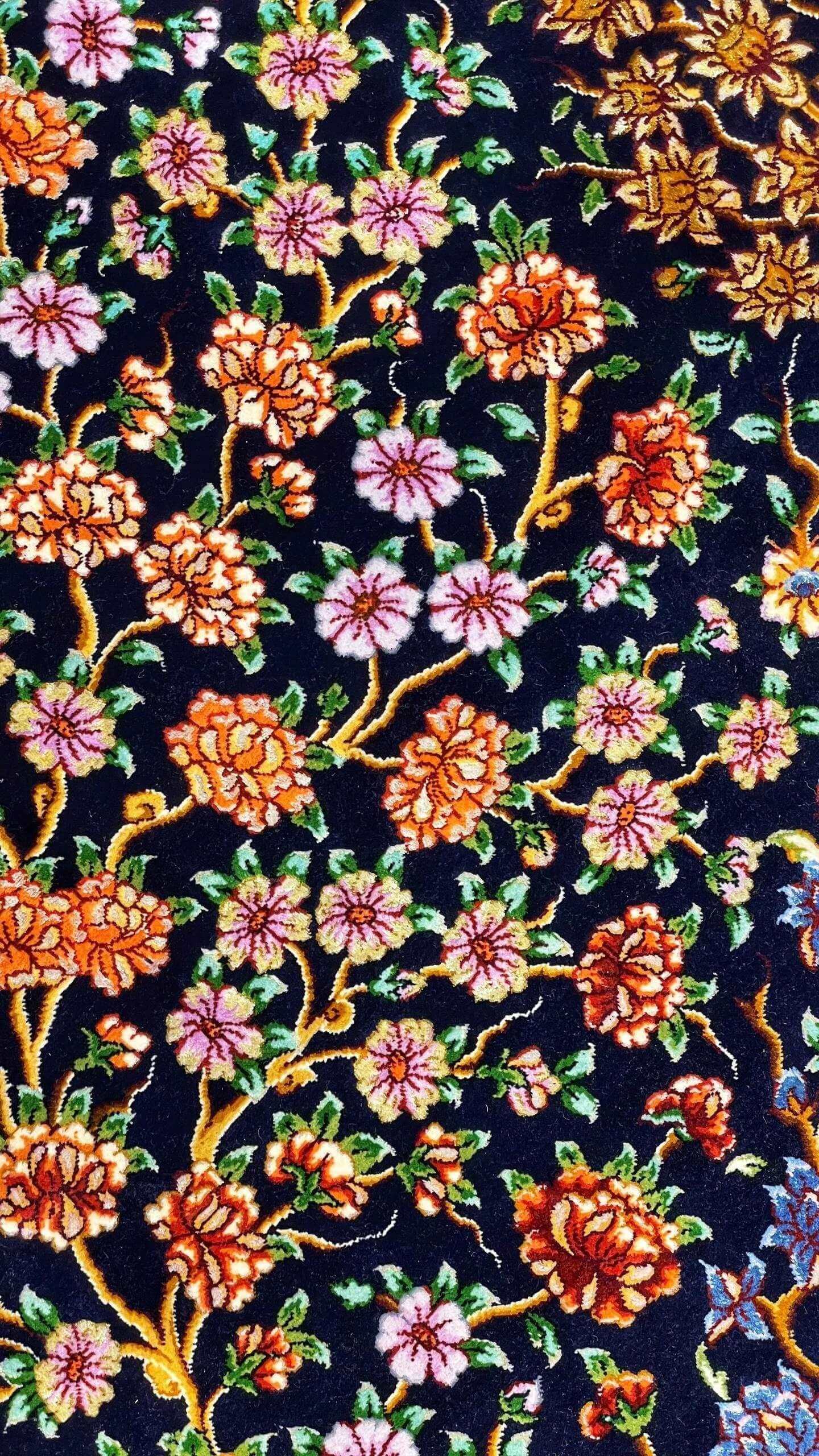 Detailed image of the Tree of Life design on Persian rug against a dark backdrop