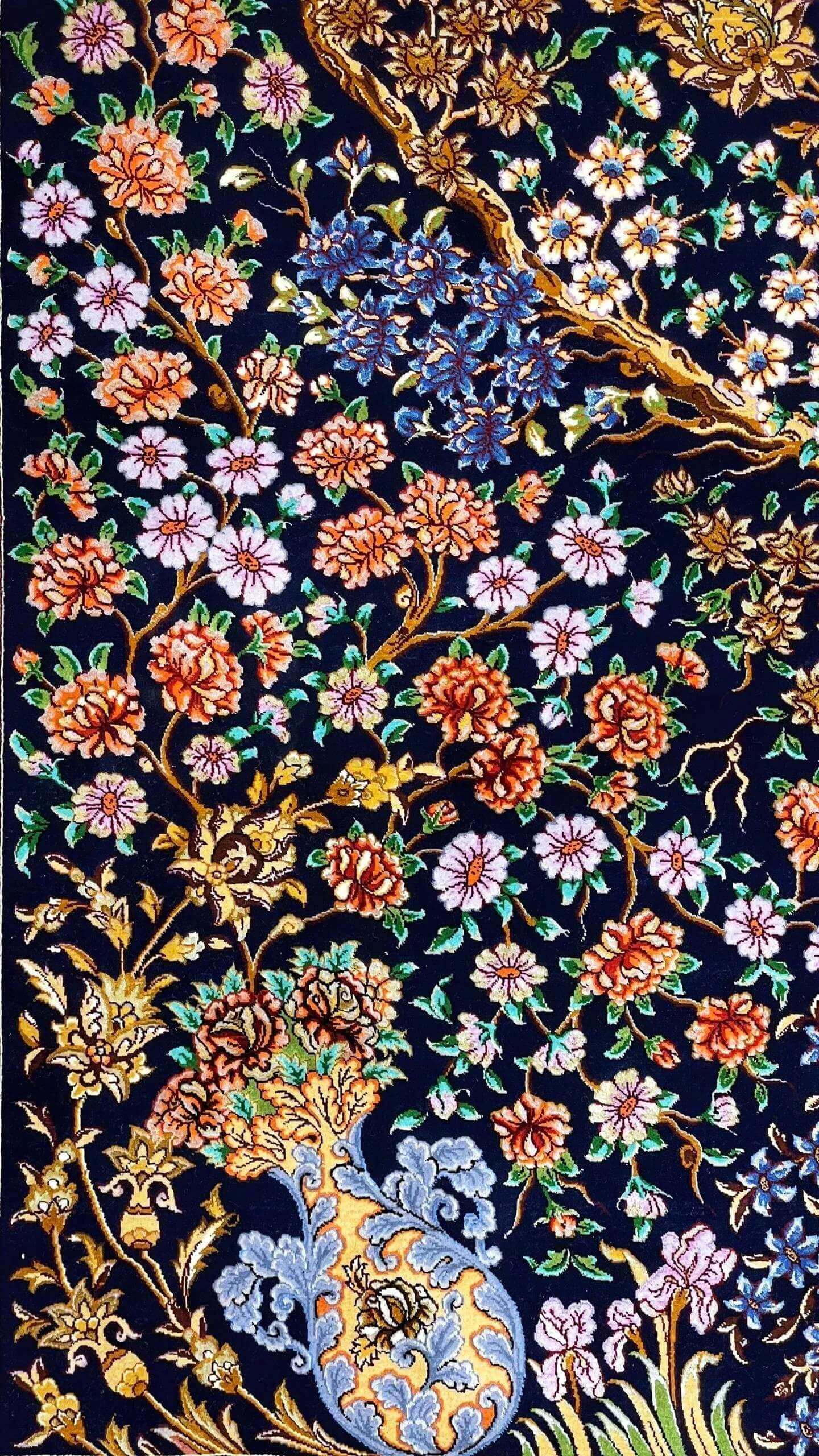 Persian rug featuring a Tree of Life pattern with gold and blue floral accents on a black field