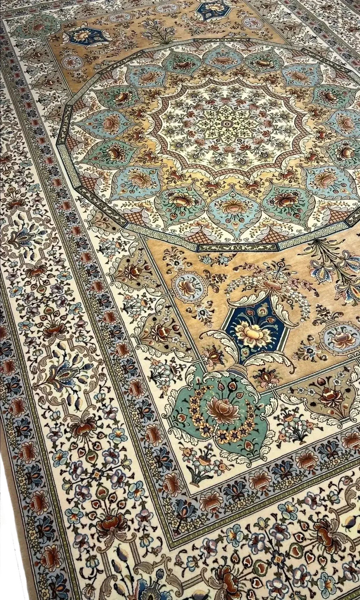 Traditional silk-wool blend rug from Iran with prominent medallion pattern