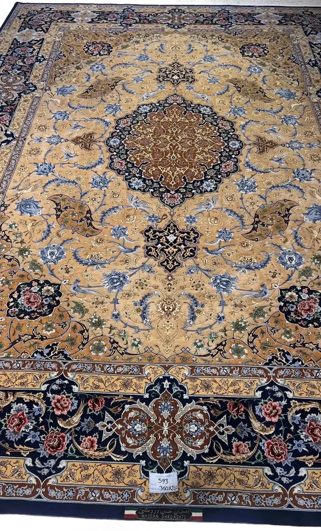 Handmade Persian Silk Rug by Master Weaver Hassan Dardashtie
A luxurious, hand-knotted Persian silk and wool rug crafted by Master Hassan Dardashtie. This large rug, measuring 320x220 cm (10.5x7.2 feet), features intricate floral designs in rich gold, blue, and brown tones, with a knot density of 1,000,000 knots per square meter.