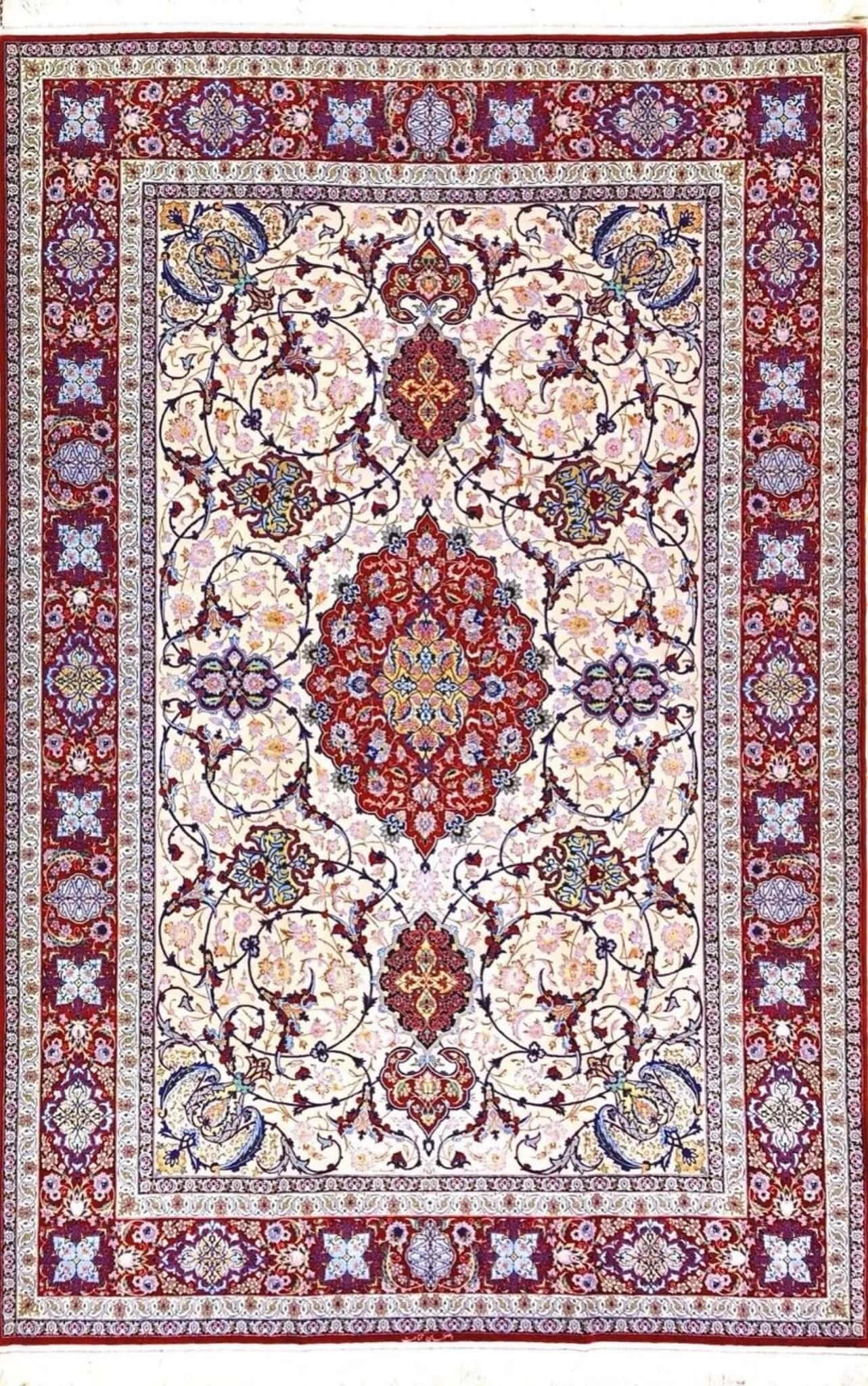 Detailed view of Ghenaat Isfahan handmade rug showcasing intricate floral motifs with red, blue, and cream tones.

