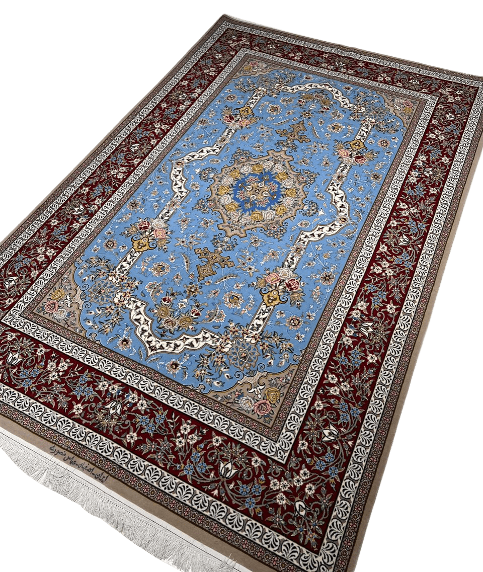 Traditional Persian rug from Isfahan with a detailed floral design, highlighted by a blue and gold medallion, crafted from wool and silk for a luxurious texture.
