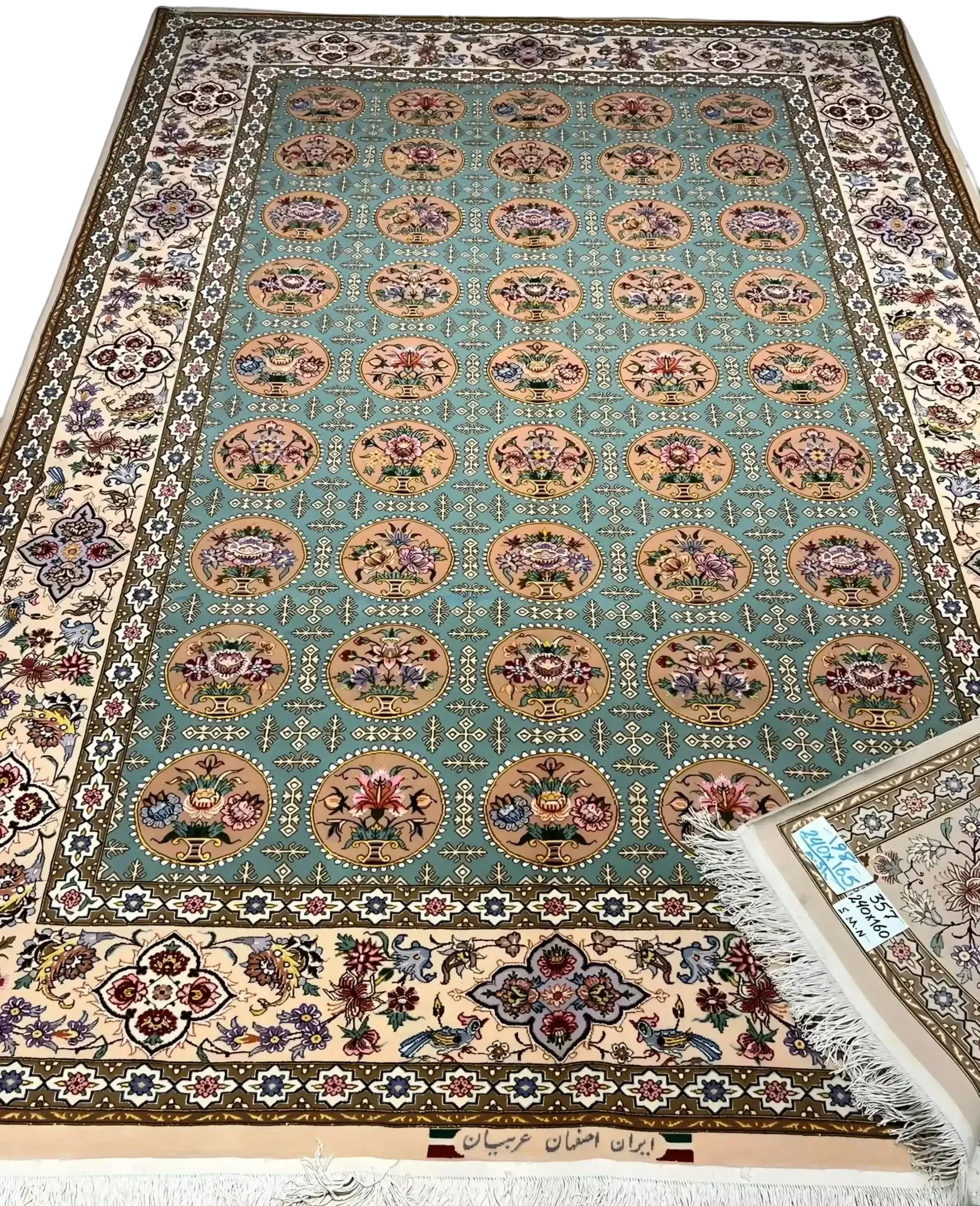 Close-up of a fully framed Isfahan rug showcasing its blue and green design elements