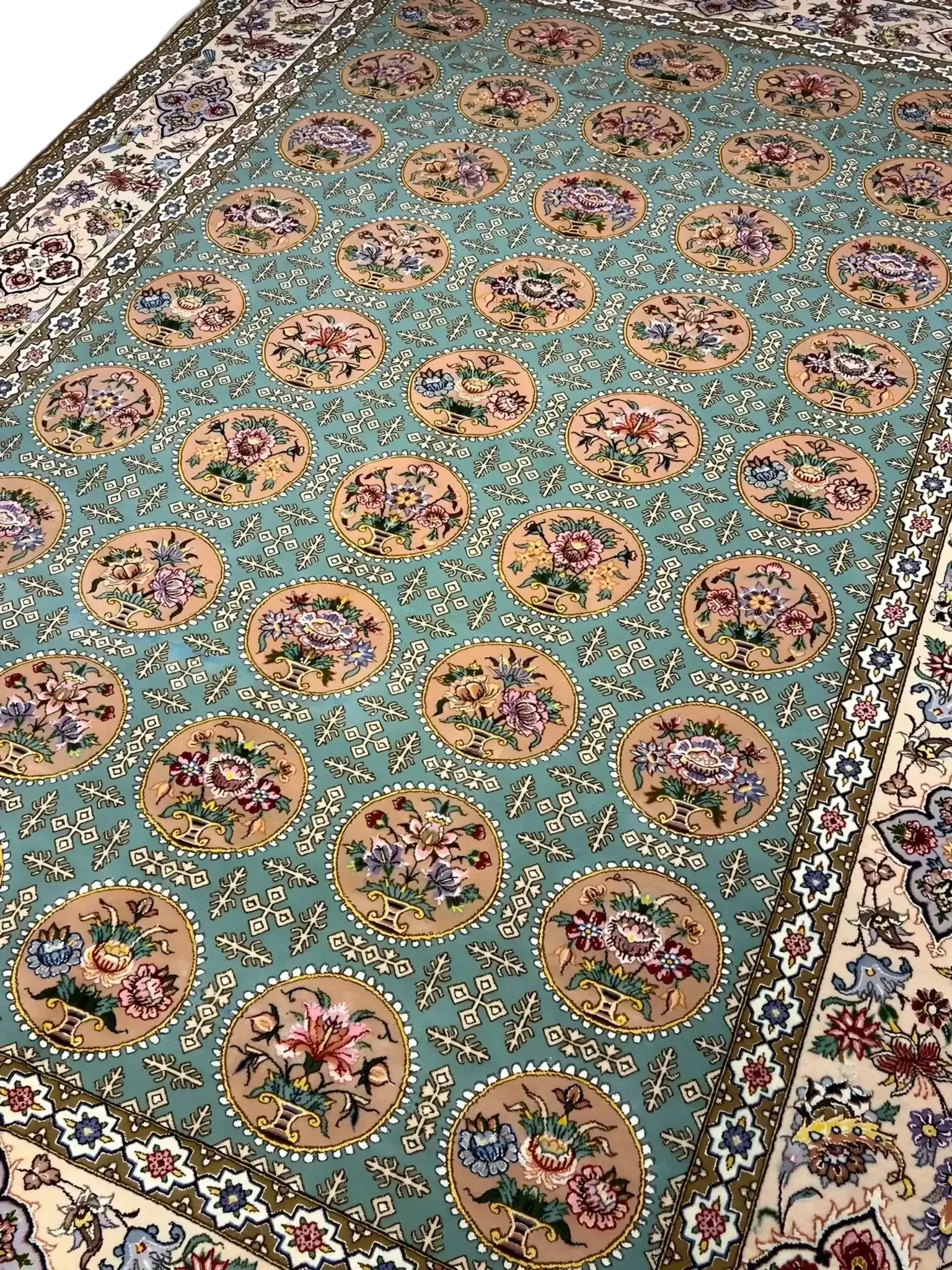 A detailed view of the floral motifs on an Isfahan rug with full framing