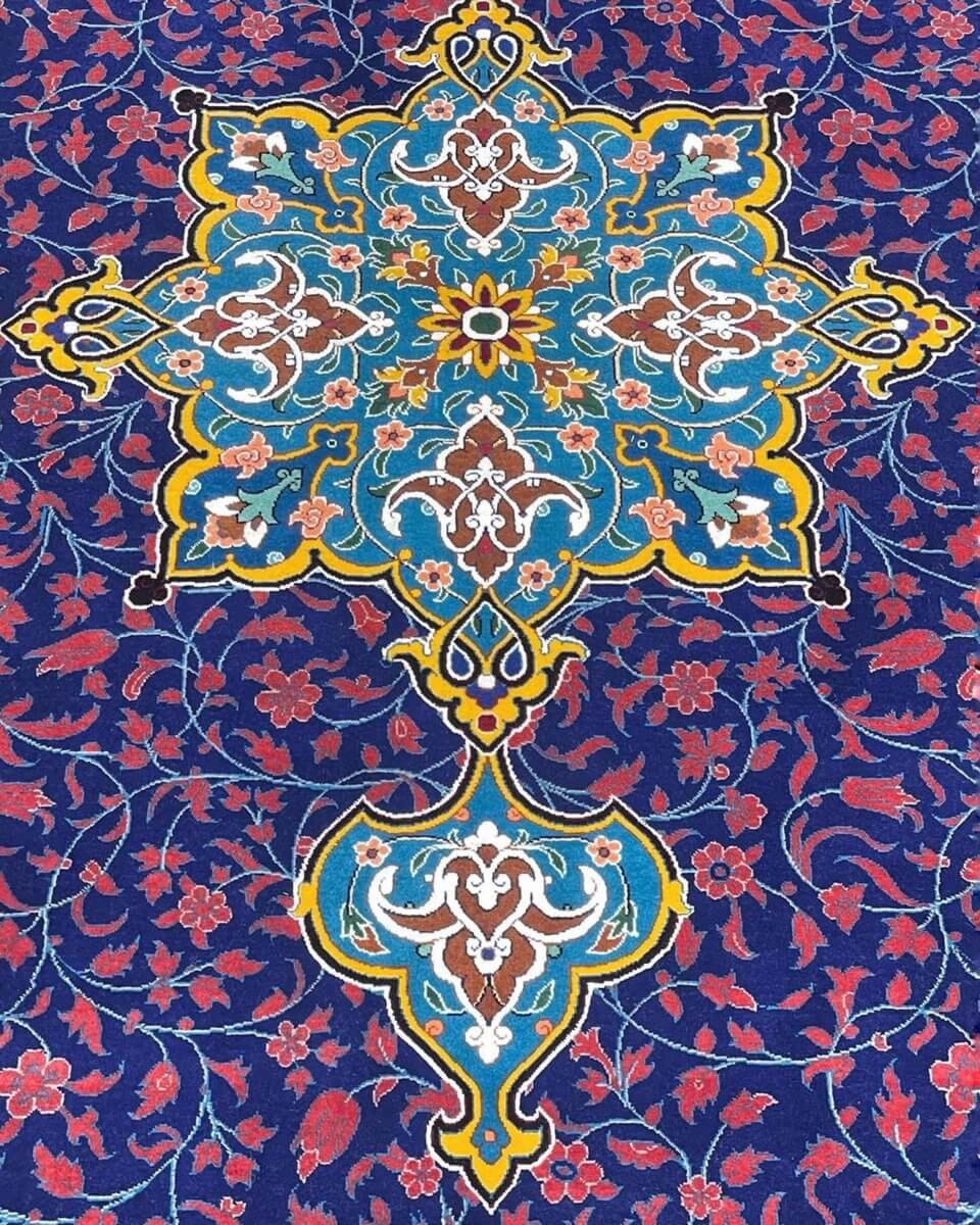 Persian Silk and Wool Rug - A close-up of the rug's border showcasing the elegant design, vibrant floral motifs, and superior craftsmanship in blue, gold, and cream tones.

