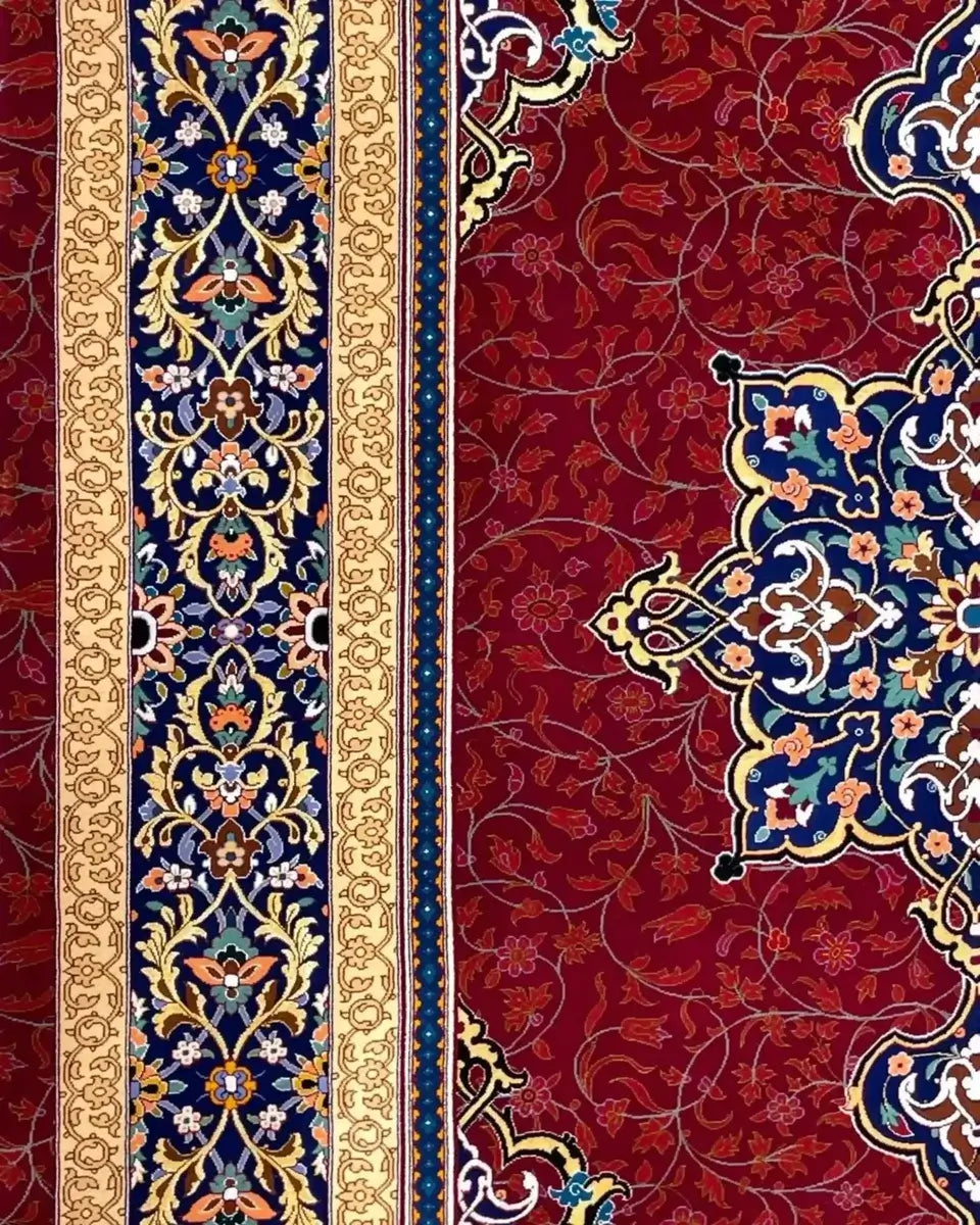 Handmade Persian Rug from Isfahan, Iran - An angled shot of a Persian rug displaying the rich red background with golden floral patterns and a complex blue medallion in the center.

