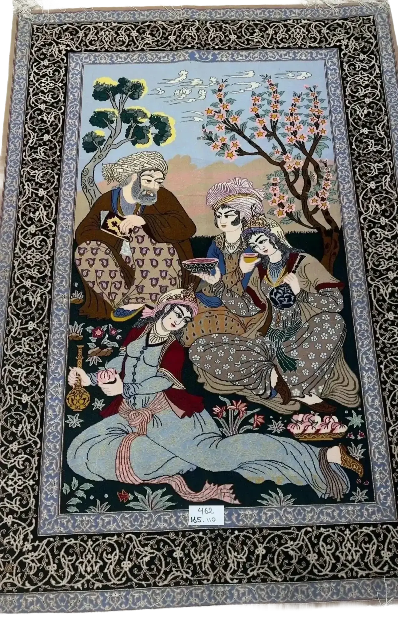 Traditional Isfahan Persian carpet depicting a gathering of individuals in a garden setting