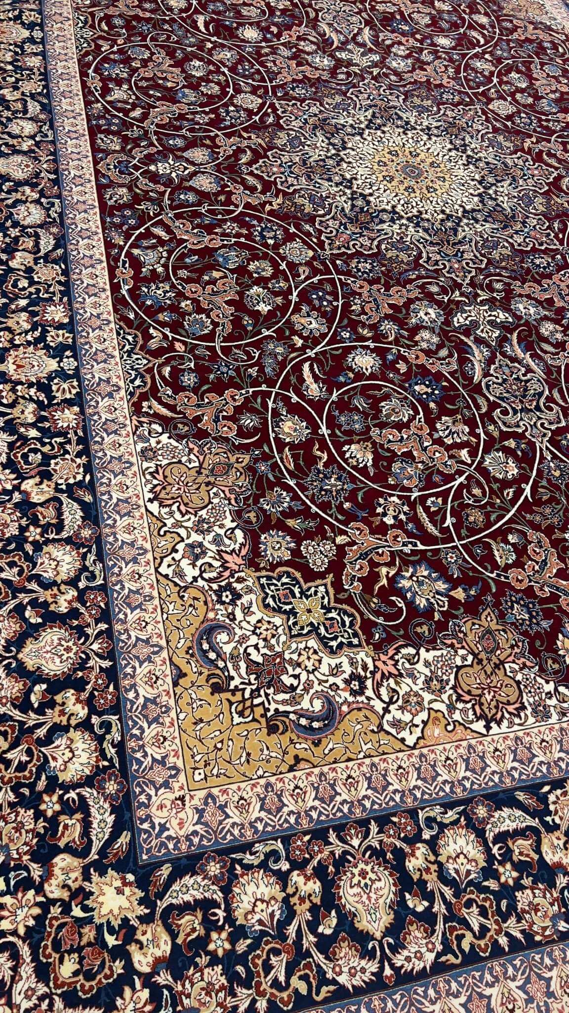 "Close-up of floral and vine patterns on a wool-silk Isfahan rug."
